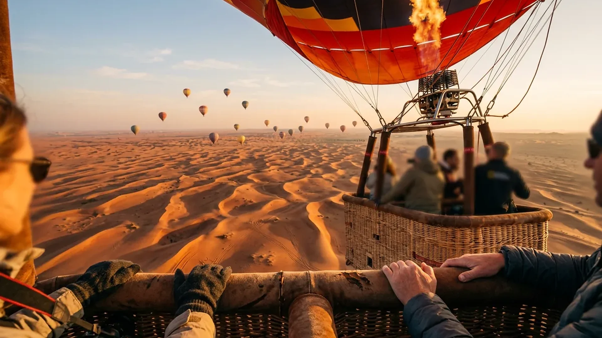Hot air balloon inflating at dawn in the Dubai desert with ground crew